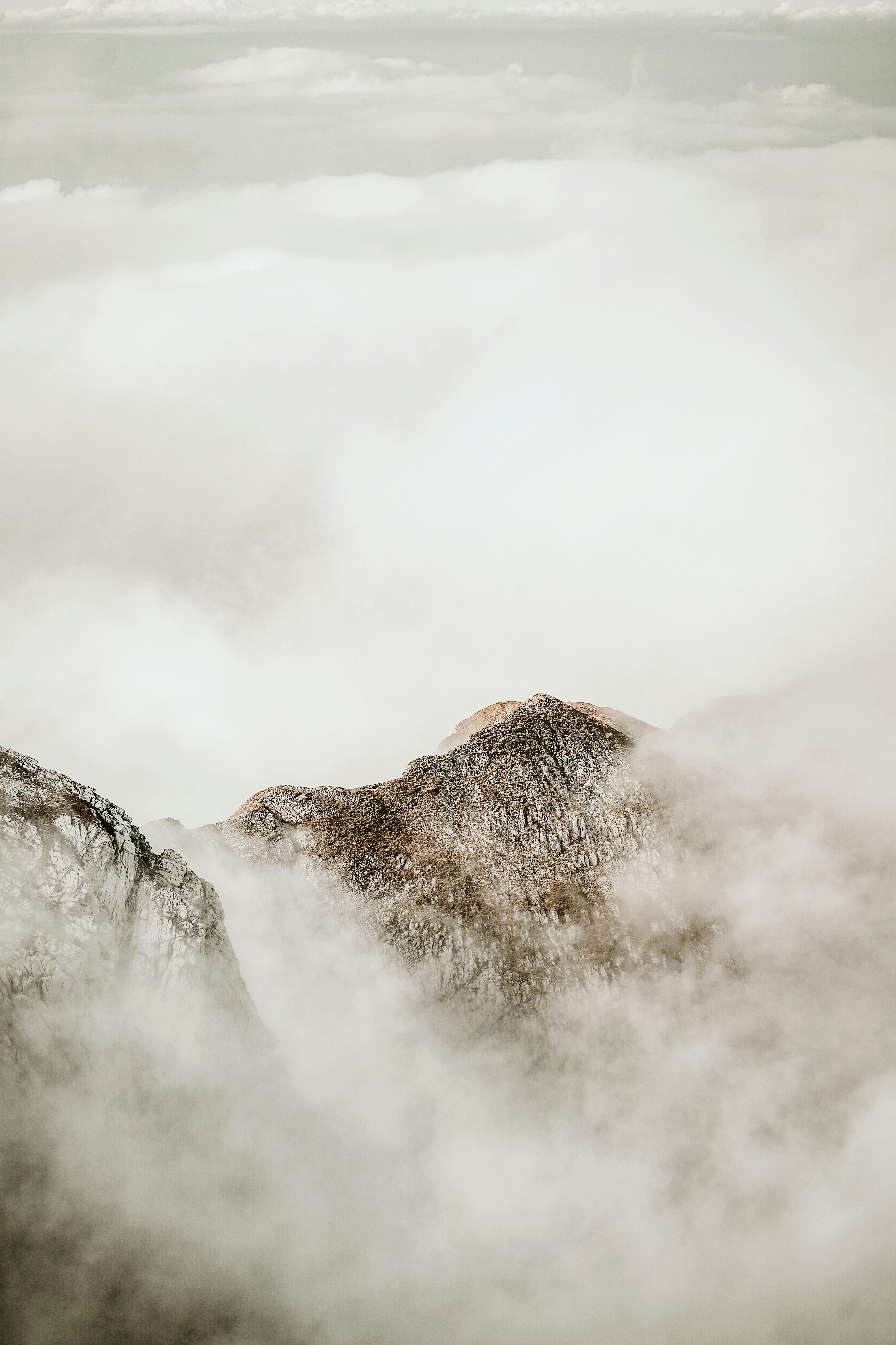 brown mountain covered with white clouds